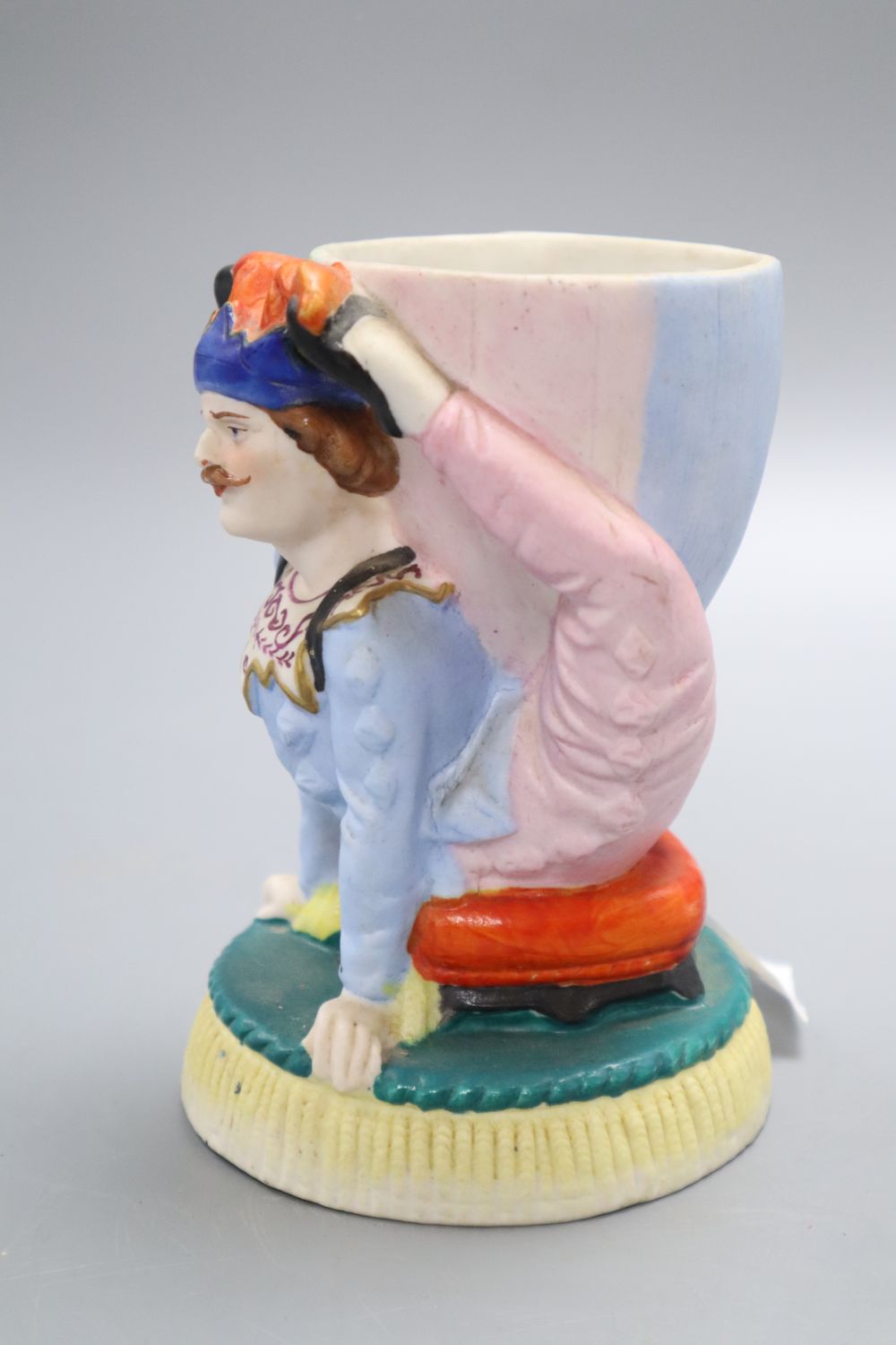 A French coloured biscuit acrobat cup, height 14cm